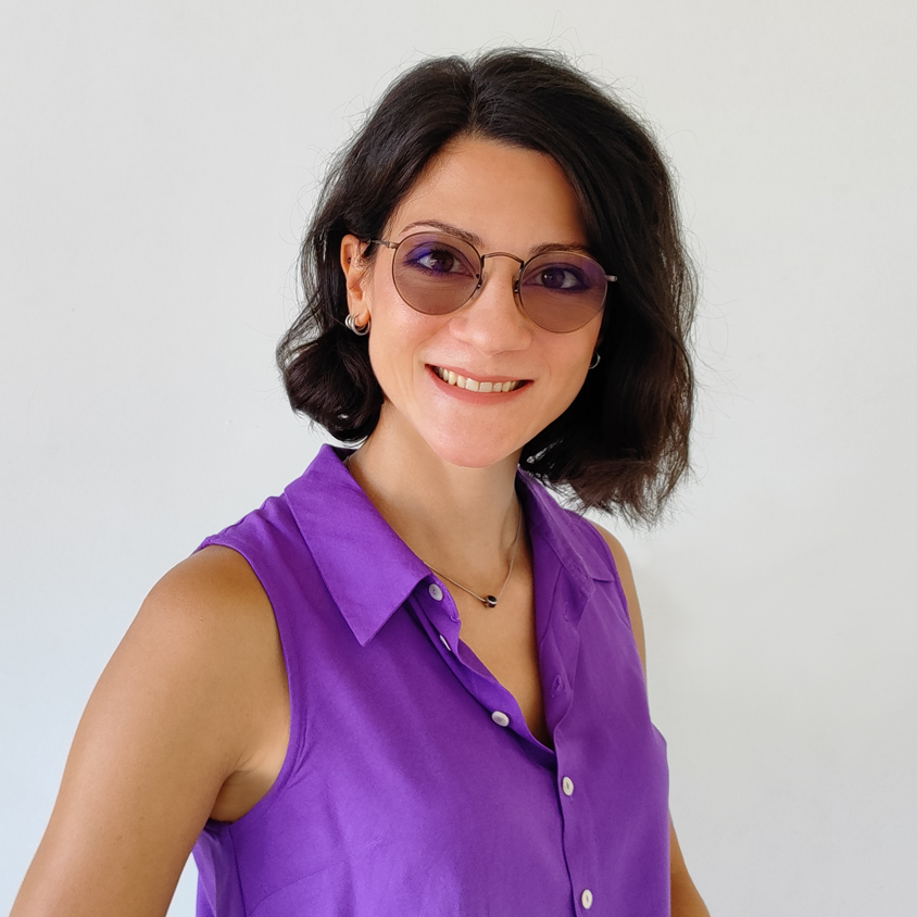 Portrait of a person wearing a purple shirt and smiling